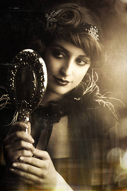 istock retro beauty lookin at herself in a silver hand mirror 170606213