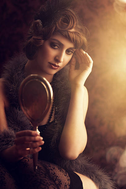 istock retro beauty lookin at herself in a silver hand mirror 170606316