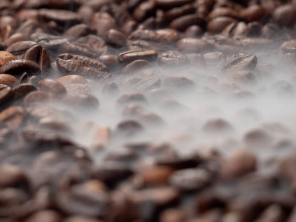 istock Close-up of roasted coffee beans with smoke. 1706066580