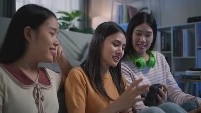 Group of Young Women Enjoy listening music through cassette tape player at Home