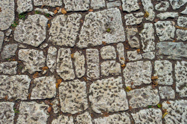 Texture of antique stonework fills entire frame. Abstract background.