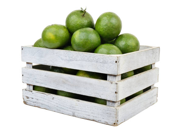 istock Green oranges in wooden crate isolated on white 1706106772