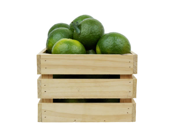 istock Green oranges in wooden crate isolated on white 1706106773