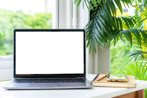 istock Mockup of laptop computer with empty screen with notebook,ice coffee and smartphone on table side the window in the coffee shop at the cafe,White screen 1706108209