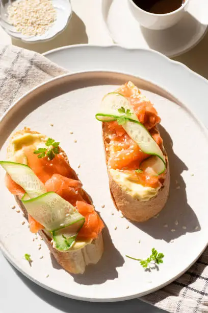 Breakfast in Scandinavian stylet: sandwiches with smoked salmon, cream cheese mousse and cucumber.  Healthy natural quick recipes. Natural beautiful light