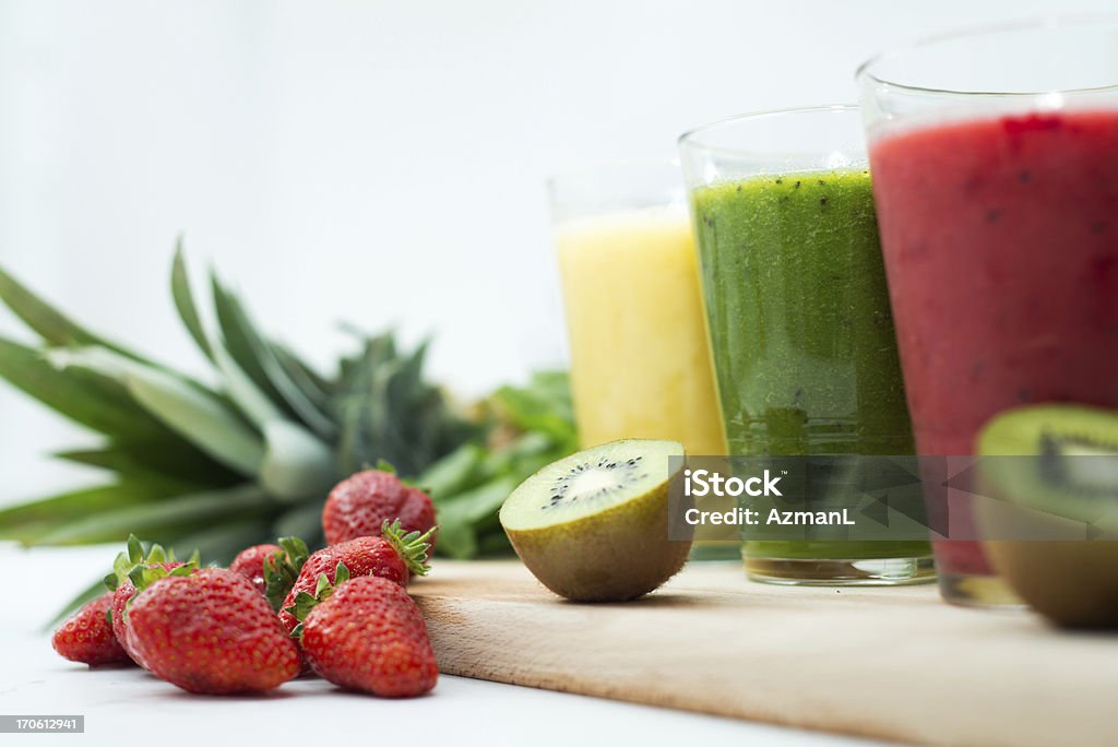Fresh, healthy smoothies Three fresh, colorful smoothies with some fruit on kitchen table. Juice Bar Stock Photo