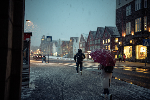 Woman in a snow storm in Bergen: typical winter weather