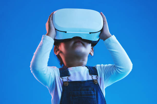 istock Future, virtual reality or metaverse with girl, glasses or  technology on a blue studio background. Futuristic, kid or child with vr headset, augmented reality or digital transformation with software 1706135554