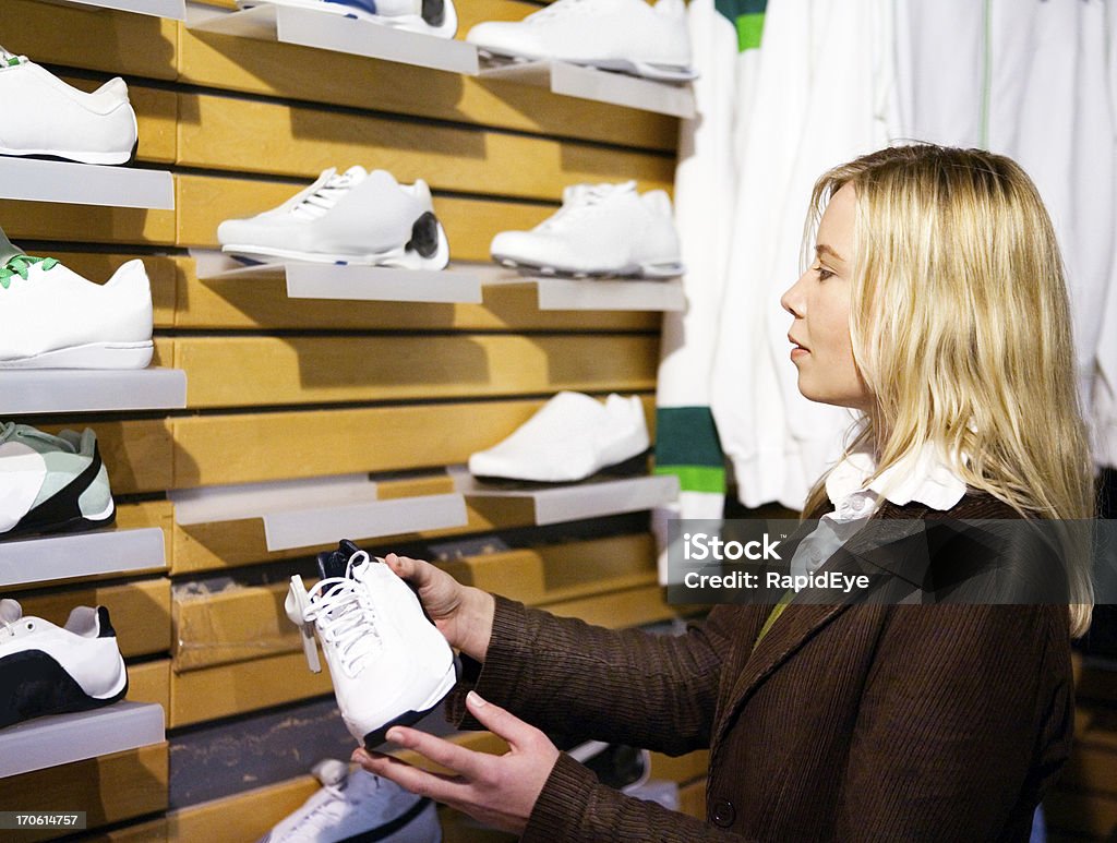Shopping for sports shoes Pretty blonde in a sports store.Camera: Canon 5D.20 pictures of this model shopping at the mall (these thumbnails are just a sample): Sports Shoe Stock Photo