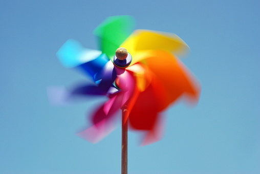 Colorful pinwheel against blue sky