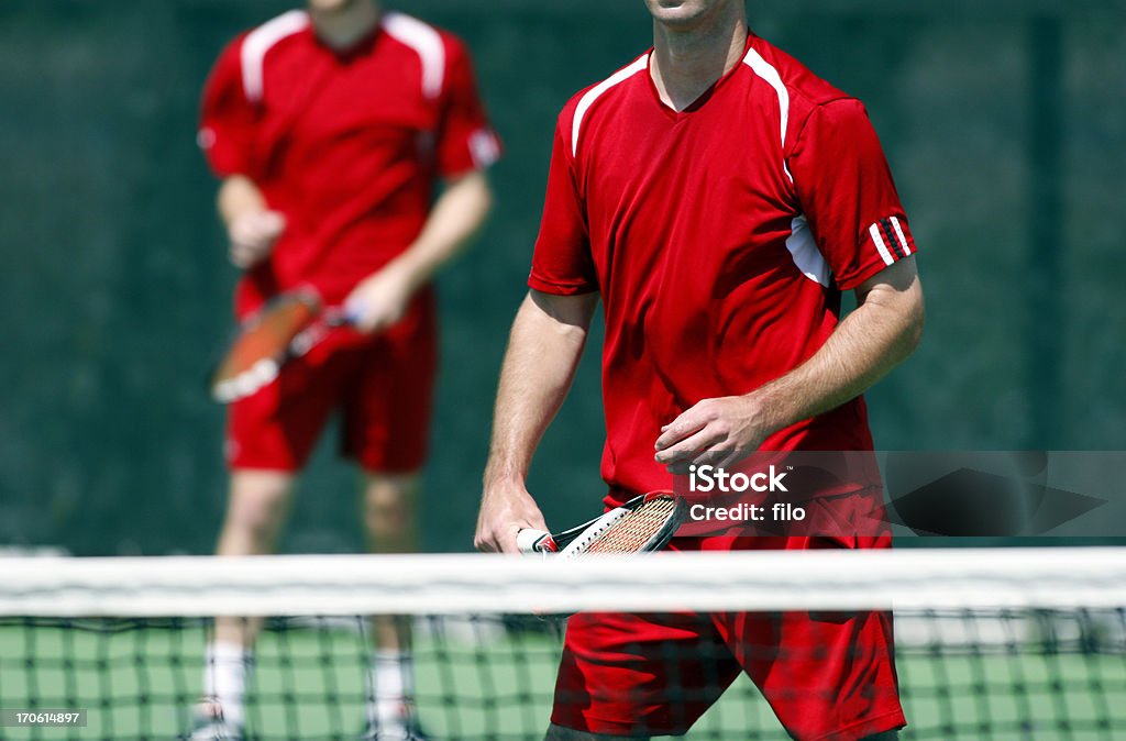 Men's Doubles Tennis Two men playing doubles tennis. University Stock Photo