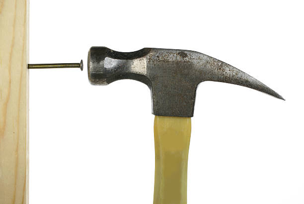 istock hammering nail in wood 170614998