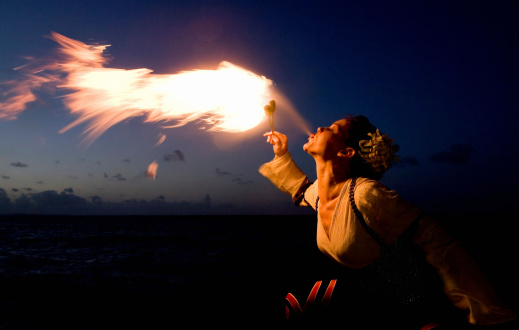 Fire breather does her magic at sunset.  Photo taken at AlohaLypse, 2007.