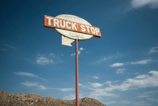 Truck Stop sign on a desert highway.