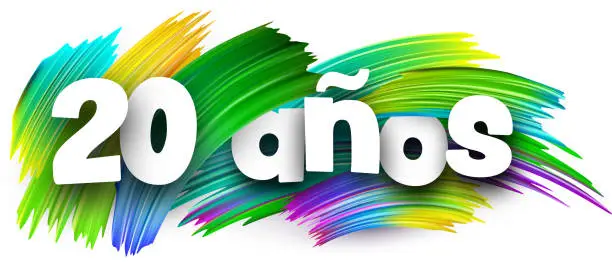 Vector illustration of 20 years at spanish paper word sign with colorful spectrum paint brush strokes over white.