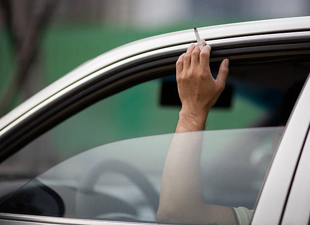 driving and smoking stock photo