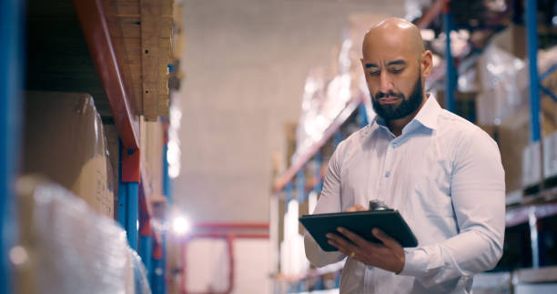 istock Distribution warehouse, man and tablet for logistics industry, export and factory. Manufacturing, supply chain and manager person with technology for inventory database, inspection or freight website 1706156463