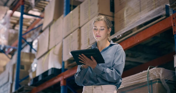 istock Woman, tablet and working in storage warehouse, export distribution and industrial manufacturing. Factory management, digital software and check logistics for supply chain, inventory and update stock 1706156500