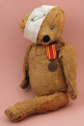 My poor old teddy bear has had a rough life.He was made during the 1930's by an unidentified, German maker.Teddy bear  is made from  plush, and is stuffed with wood shavings. He has  one attached glass eye and  has lost one leg and one ear.Very proud of his medal.Lightbox: