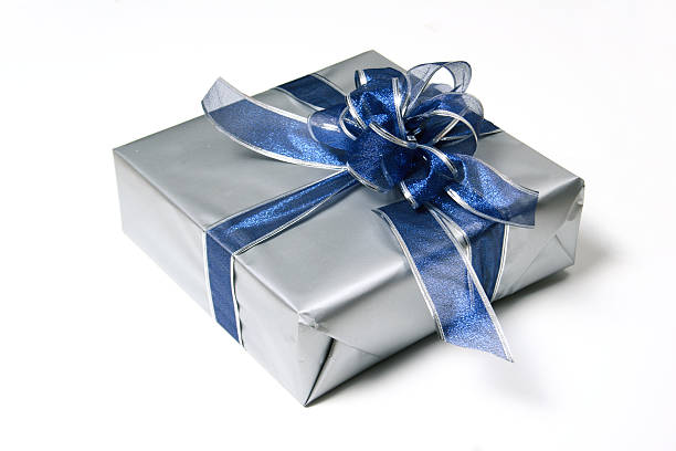 silver wrapped present with blue ribbon stock photo