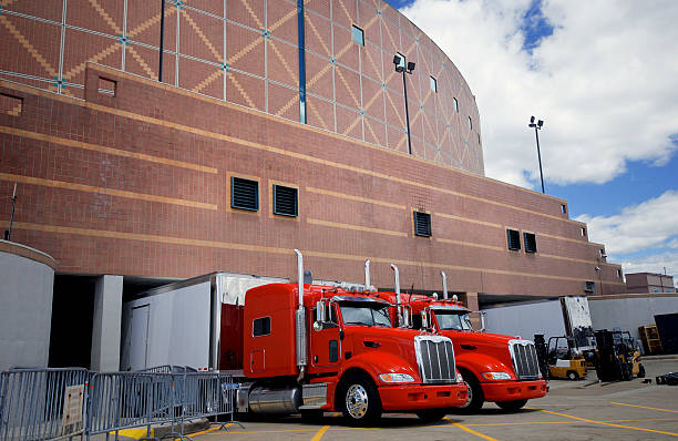 istock 2 large red trucks parked outside a brick building 170615844