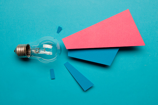 Light bulb and papers on the blue background.