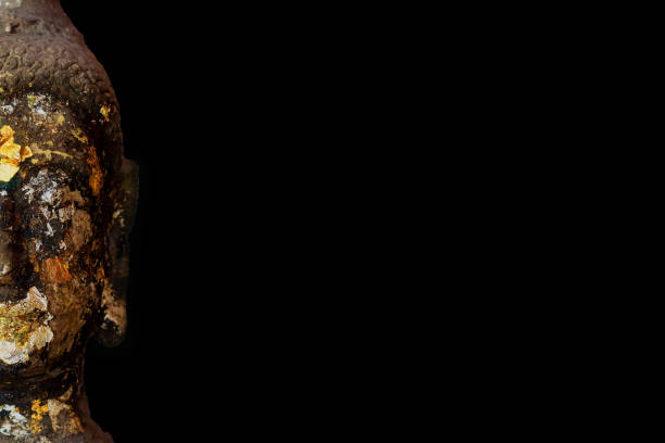 istock Half face of an ancient Buddha statue, more than 400 years old. 1706161585