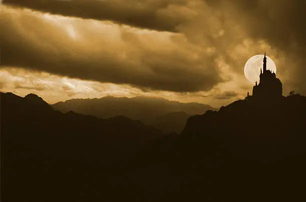 Photo of Silhouettes of a castle with full moon background behind it