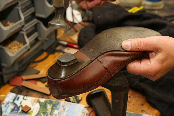 istock Shoemaker in his workshop repairing shoe 170616550