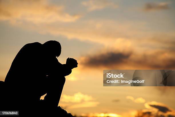 Silhouette Of Unrecognizable Man Praying Outside Stock Photo - Download Image Now - Praying, Men, In Silhouette