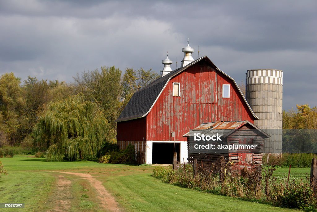 Red barn in Minnesota with a dark cloudy sky behind it Old Barn in Belle Plaine Minnesota Stock Photo
