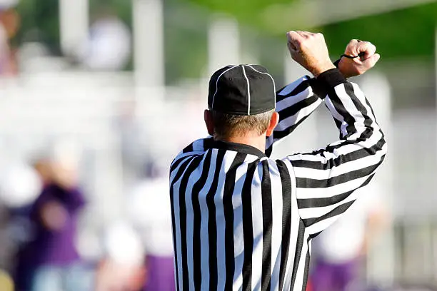 A football referee making a call.