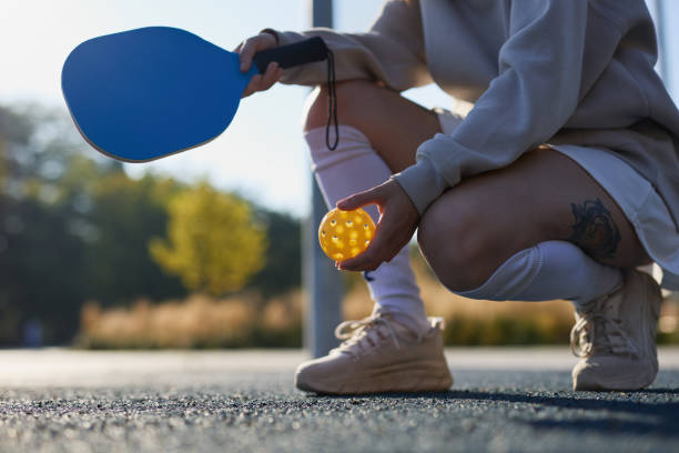 istock Pickle ball player holding a racket and plastic perforated ball 1706173545