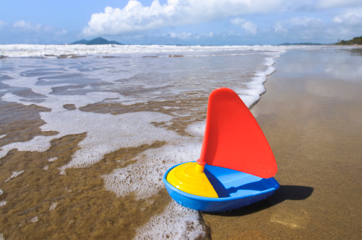 A toy boat on Mission Beach, Queensland, Australia