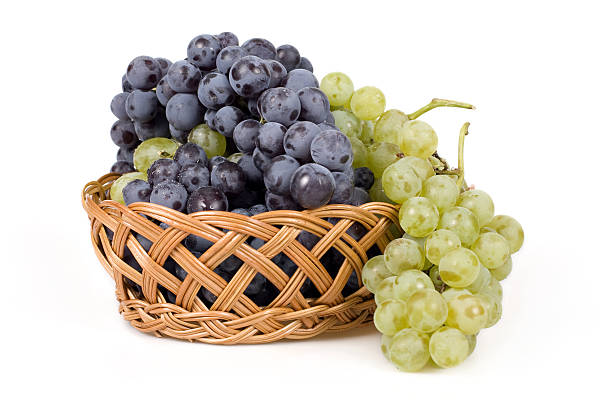 grapes in a wicker basket grapes in a wicker basket isolated on whiteMore of this Collection basket healthy eating vegetarian food studio shot stock pictures, royalty-free photos & images
