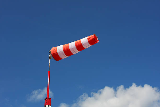 windsock against deep blue sky - rüzgar tulumu stok fotoğraflar ve resimler
