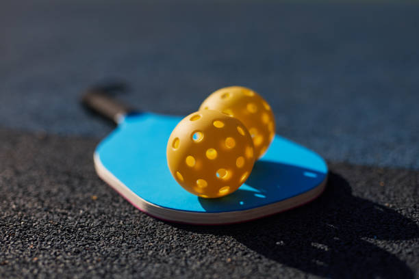 istock Pickleball racket and balls on court 1706175148