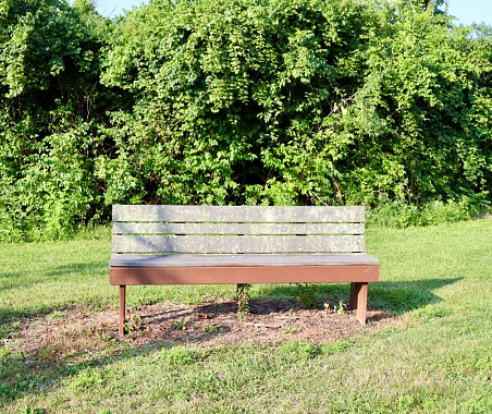 A close view of the old wood park bench in the park.