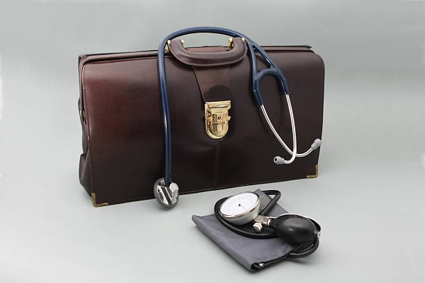 Doctor's bag with stethoscope on a gray background