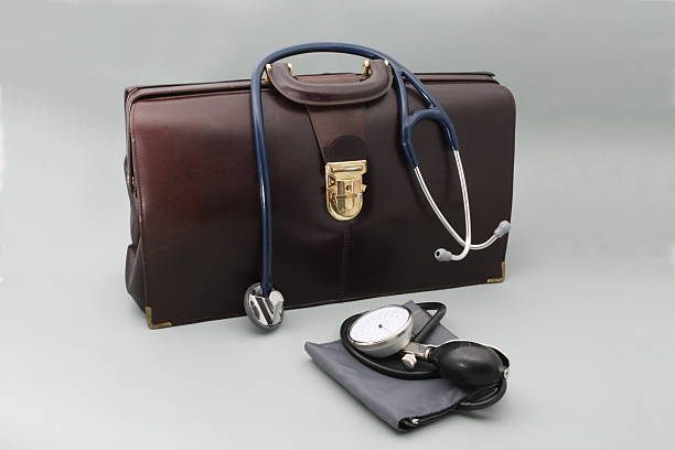 Doctor's bag with stethoscope on a gray background Doctor's equipmnet doctors bag stock pictures, royalty-free photos & images