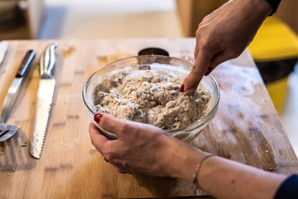 istock Cook stirring wheat flour with gluten to prepare a bread. 1706183371