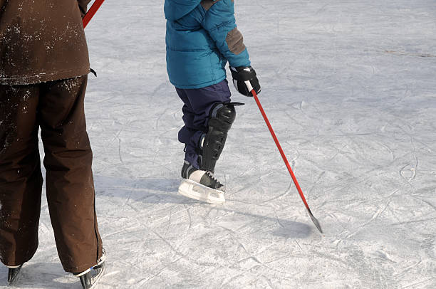 istock ice skating and playing hockey 170618413