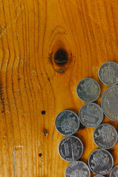 istock Group of old Spanish coins on wooden floor. 1706184480