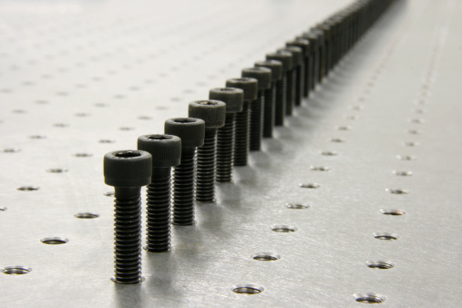 a lot of screws on fully holes table. The table is a optical table. Synonym of repetition and hard work.Check out our collections!