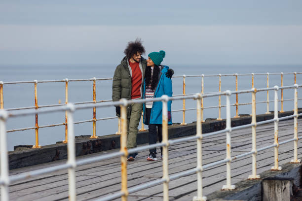 istock Couple Walking along the Promenade 1706190415