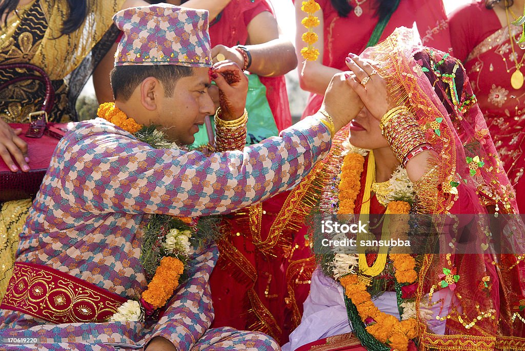 Nepalese Hindu Marriage Nepalese Hindu bride-groom exchanging tika in forehead in a marriage ceremony Bride Stock Photo