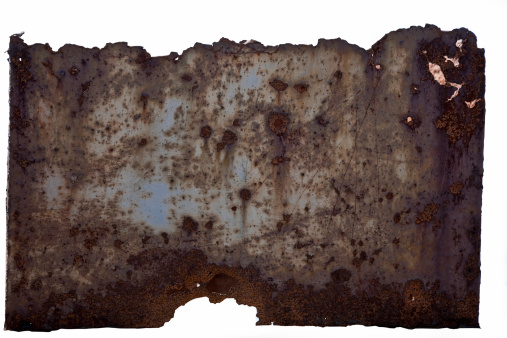 The metal surface, heavily damaged by rust, fills the entire frame.