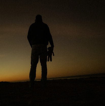 A man and his sock monkey wait for the sunrise over Edisto Island, South Carolina.