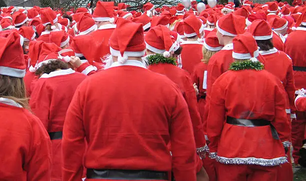 a group of santas waiting for the holidays, taking part in the annual santa run in Newton, Wales