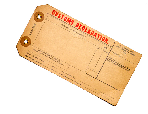 An old blank customs declaration tag. It is aged, faded and cracked with red and black text. This tag or label could be used for a variety of projects including travel, shipping and transportation. It is isolated on white for easier extraction to your project. If you don't see similar images below please visit my profile.